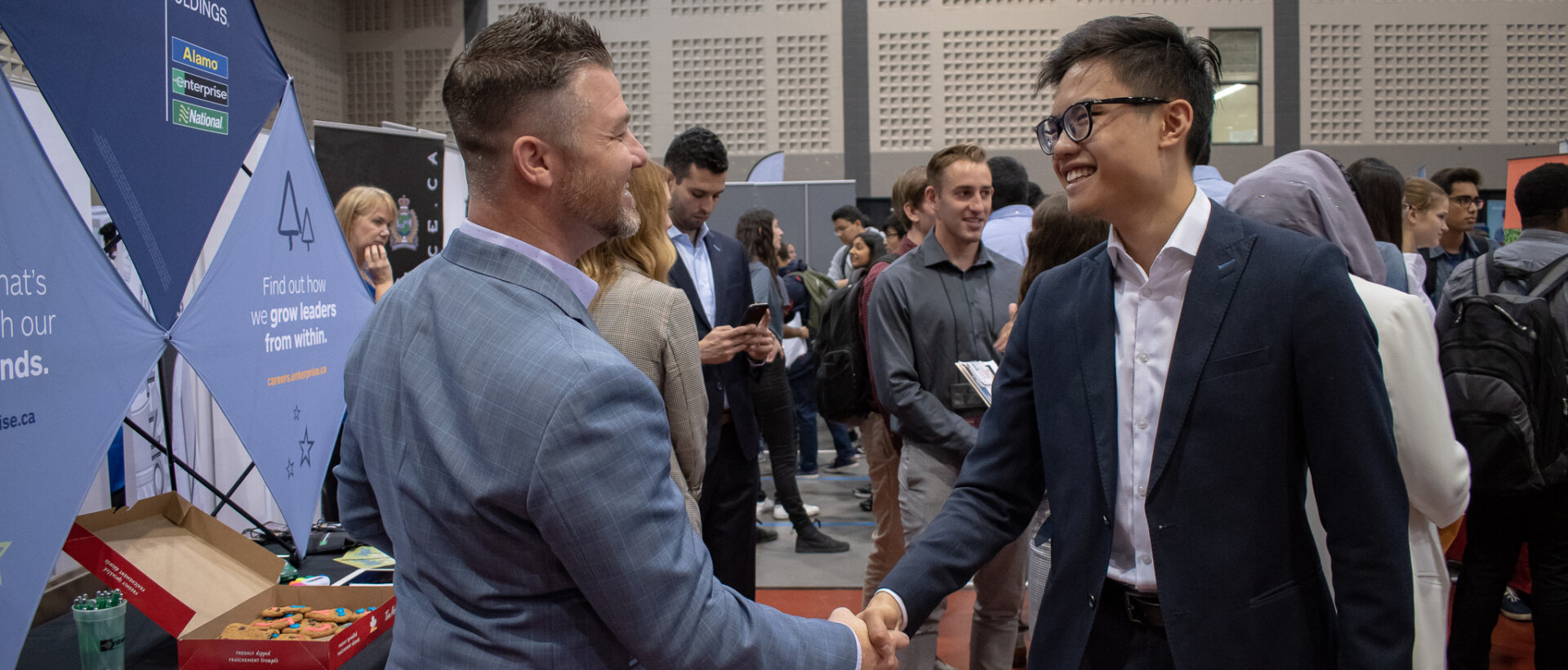 Student and employer shaking hands.