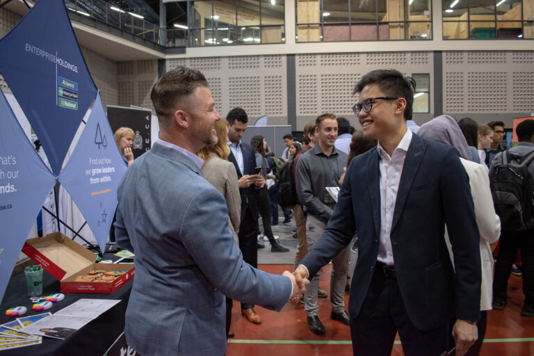 Student and employer shaking hands.