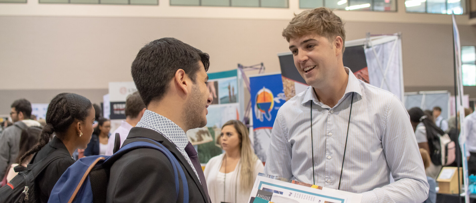 Student and organization rep at a fair.