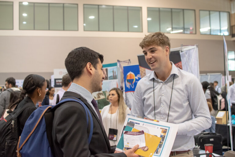 Student and organization rep at a fair.