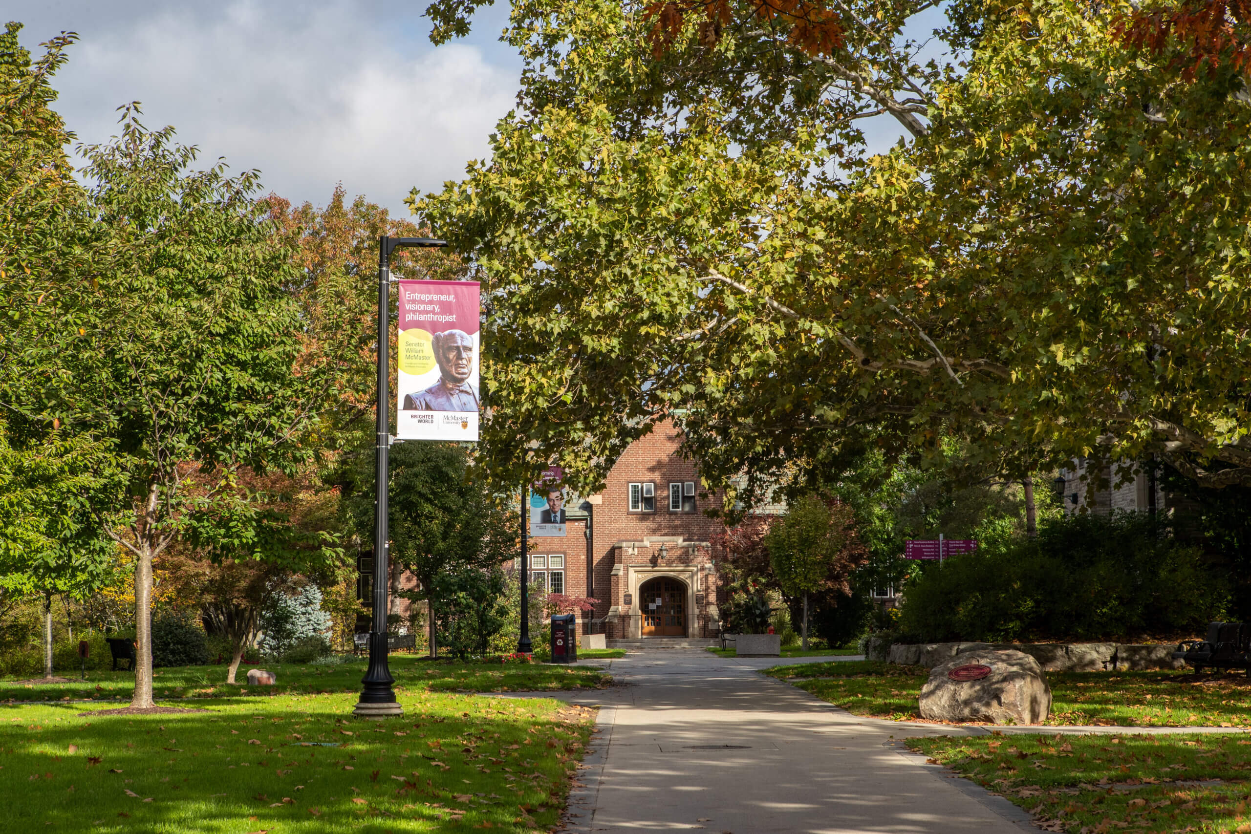 Campus banner located along pathway leading to University Club.