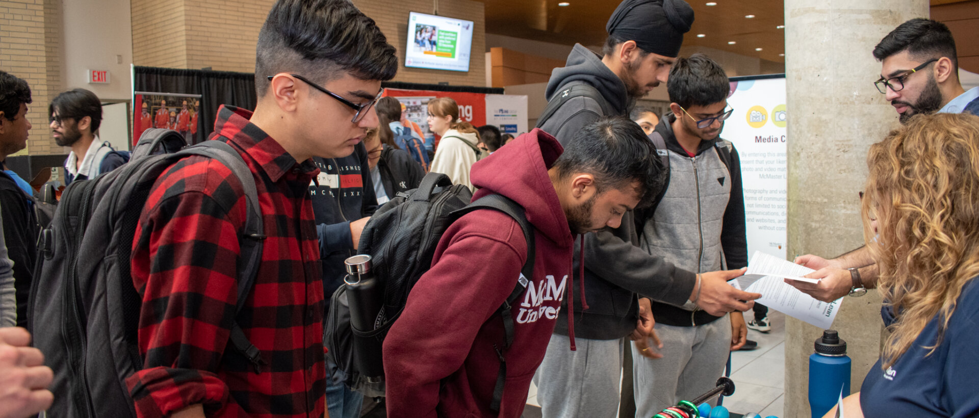 Students engaging with a booth at an event.