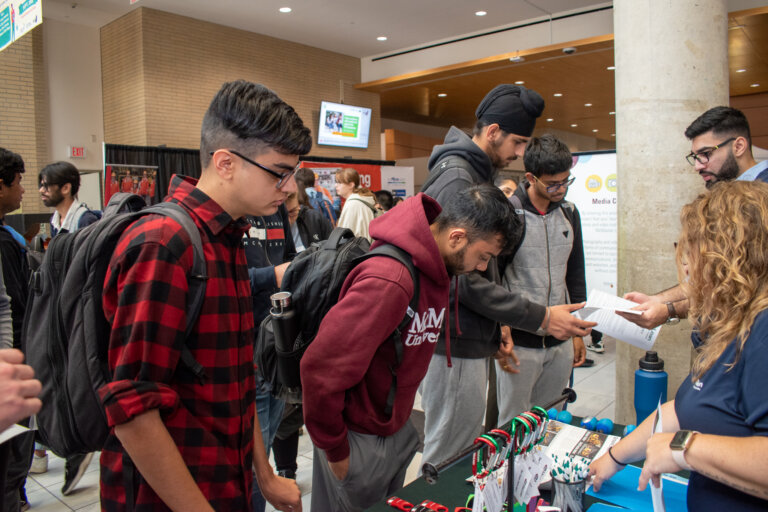 Students engaging with a booth at an event.